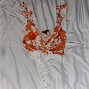 Lulu's White Asymmetrical Sleeveless Bodysuit with Tie Front